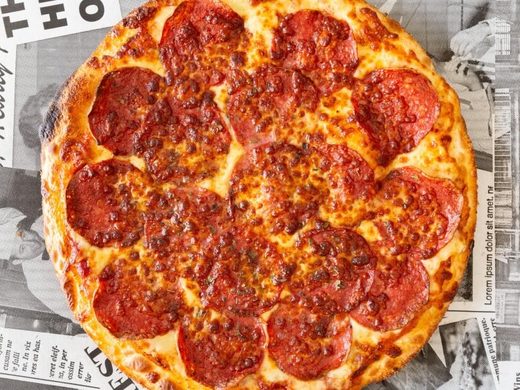 Pepperoni pizza covered edge to edge in salami