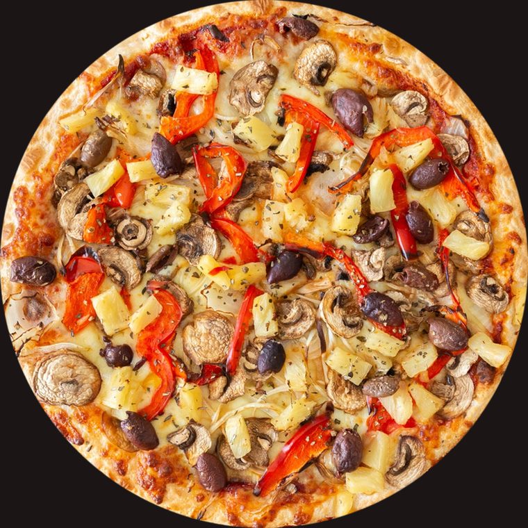 Pluto's Vegetarian pizza from above, topped with mushrooms, olives, red capsicum and pineapple